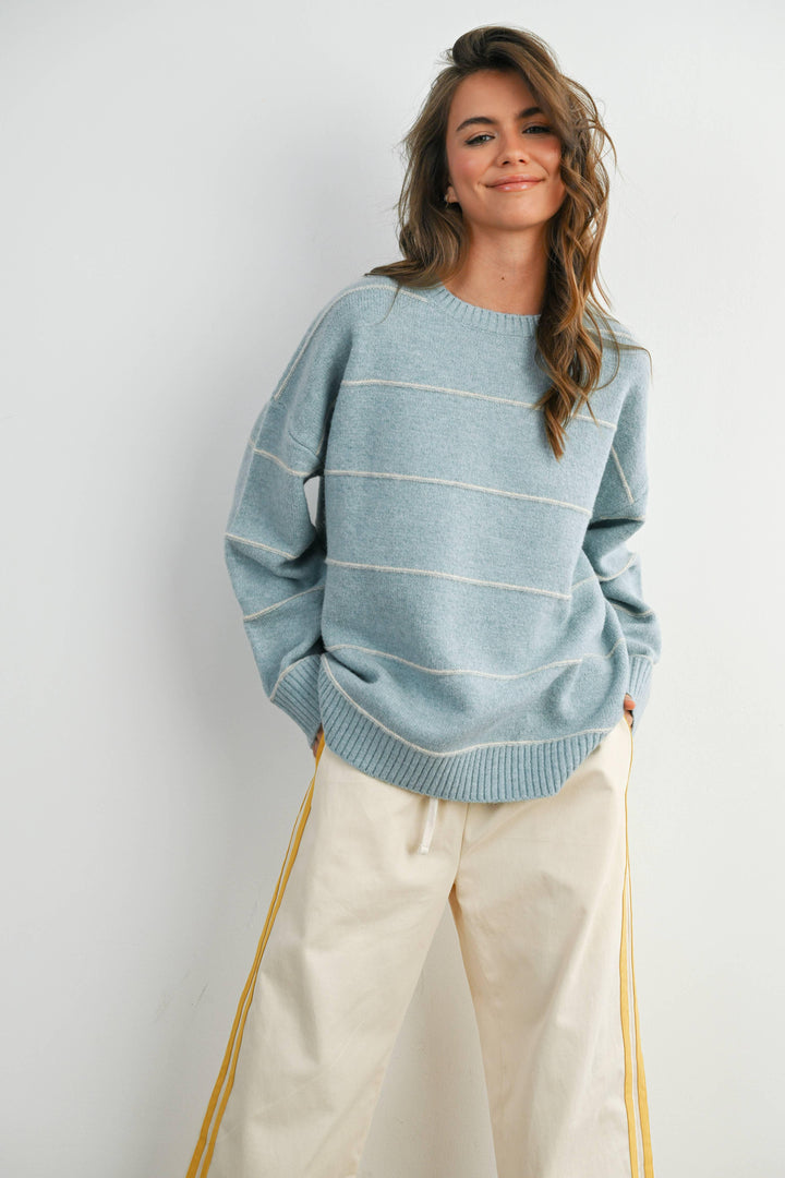 Woman in light blue striped sweater and cream joggers, coastal PNW style