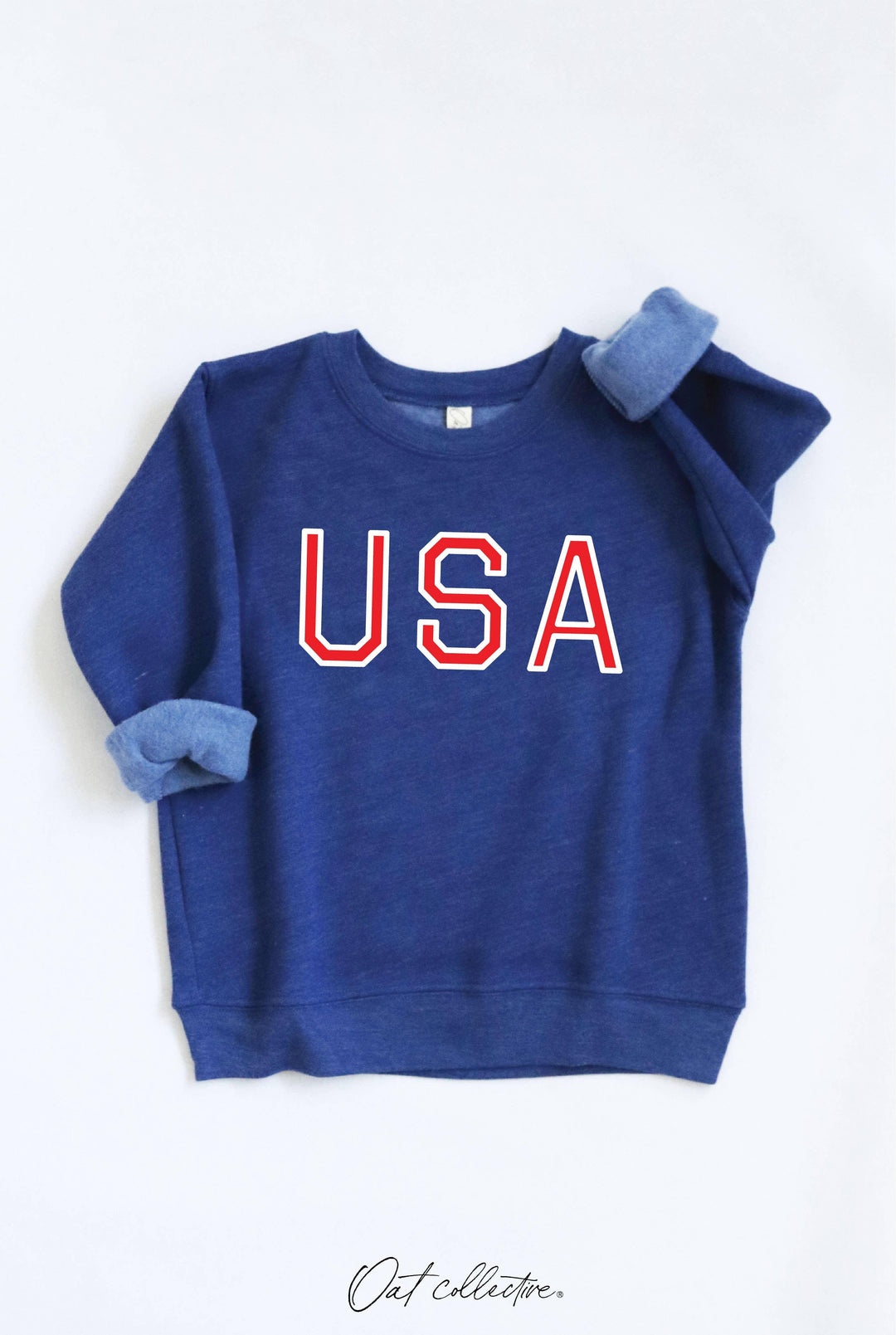 Blue USA graphic sweatshirt with red and white lettering, rolled sleeves, coastal lifestyle apparel