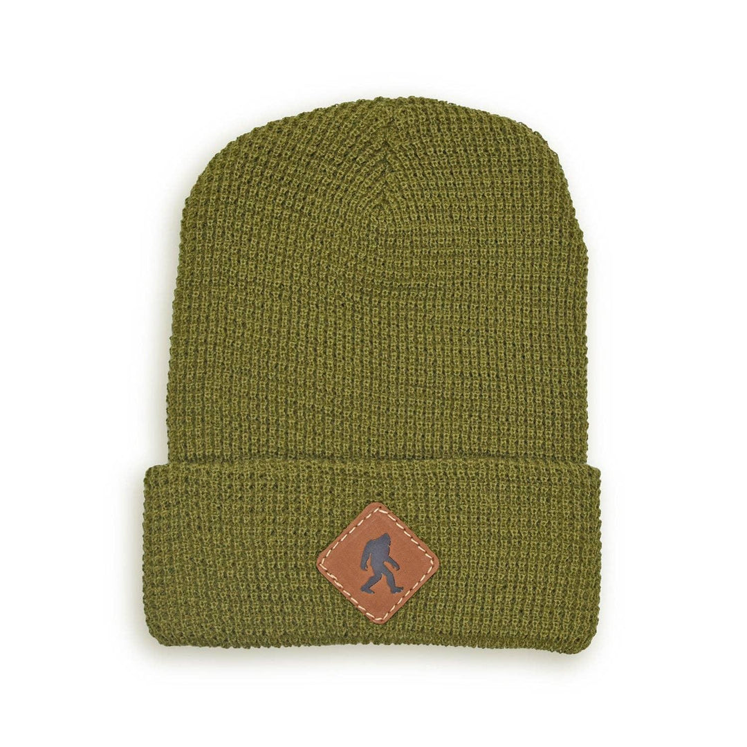 Olive green waffle knit beanie with Sasquatch patch, perfect for PNW outdoor adventures and coastal style.