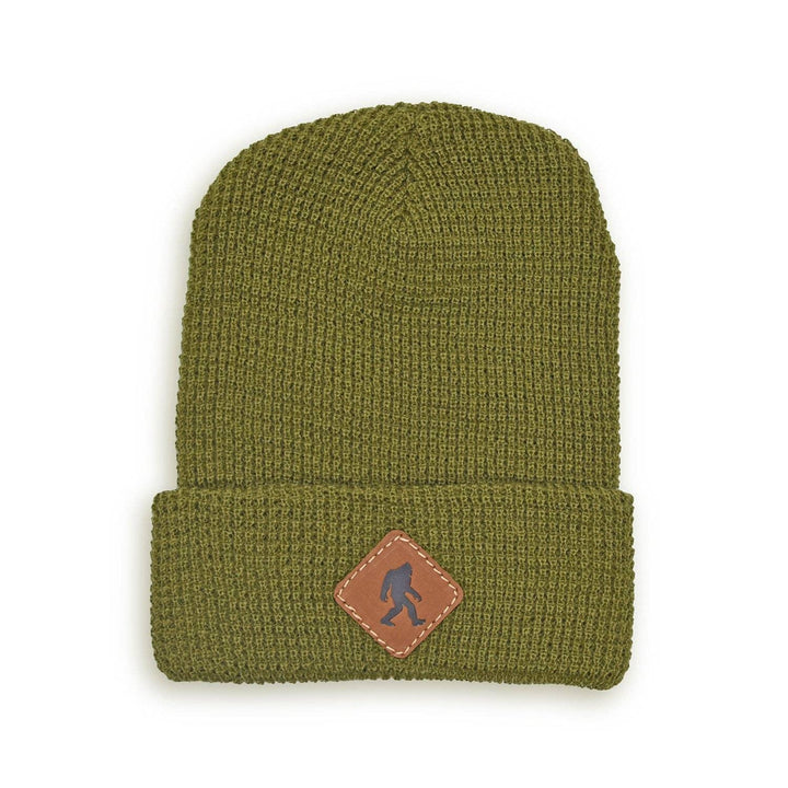 Olive green waffle knit beanie with Sasquatch patch, perfect for PNW outdoor adventures and coastal style.