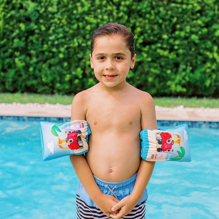 Child wearing car-themed floaties by pool, enjoying swim time