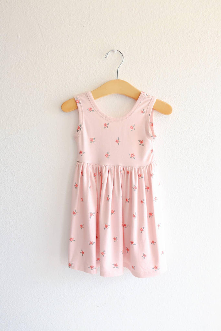 Pink floral toddler dress on wooden hanger, perfect for beach days and coastal adventures