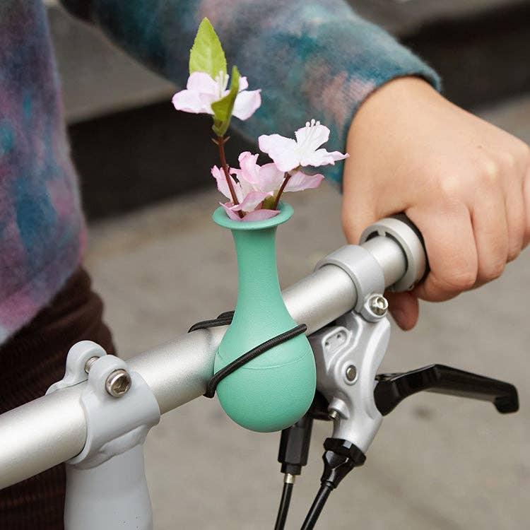 Mint bike handlebar vase with pink flowers, perfect for coastal PNW adventures and bike rides.