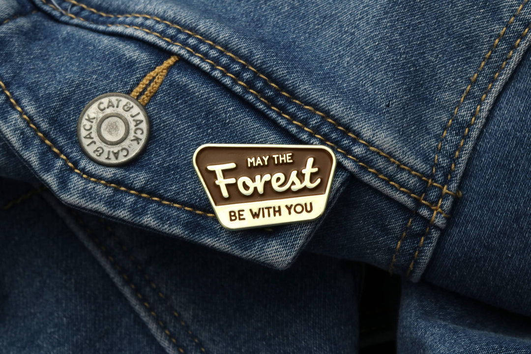 Squatchy enamel pin reading &