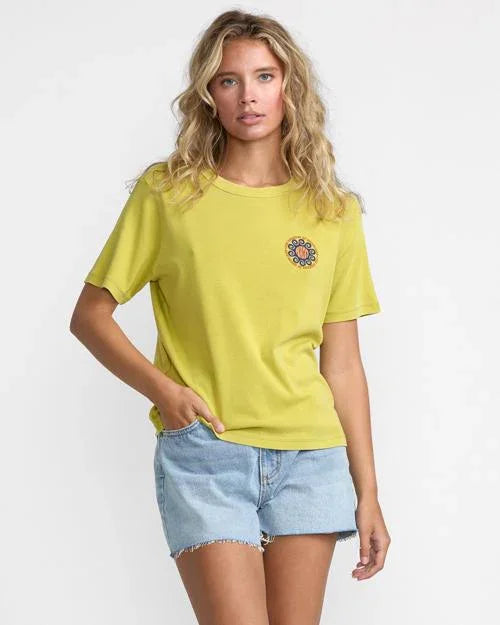 Lime green graphic tee with floral emblem, paired with denim shorts for coastal PNW style