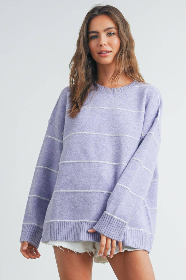 Lavender striped oversized sweater with ribbed cuffs and hem, paired with denim shorts