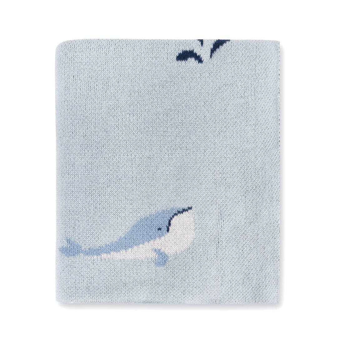 Light blue knitted blanket with whale design, soft texture, nautical theme