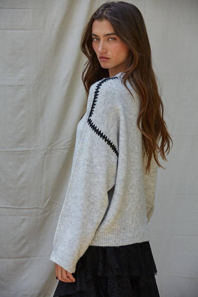 Light gray sweater with black zigzag detail, coastal style knitwear for PNW adventures