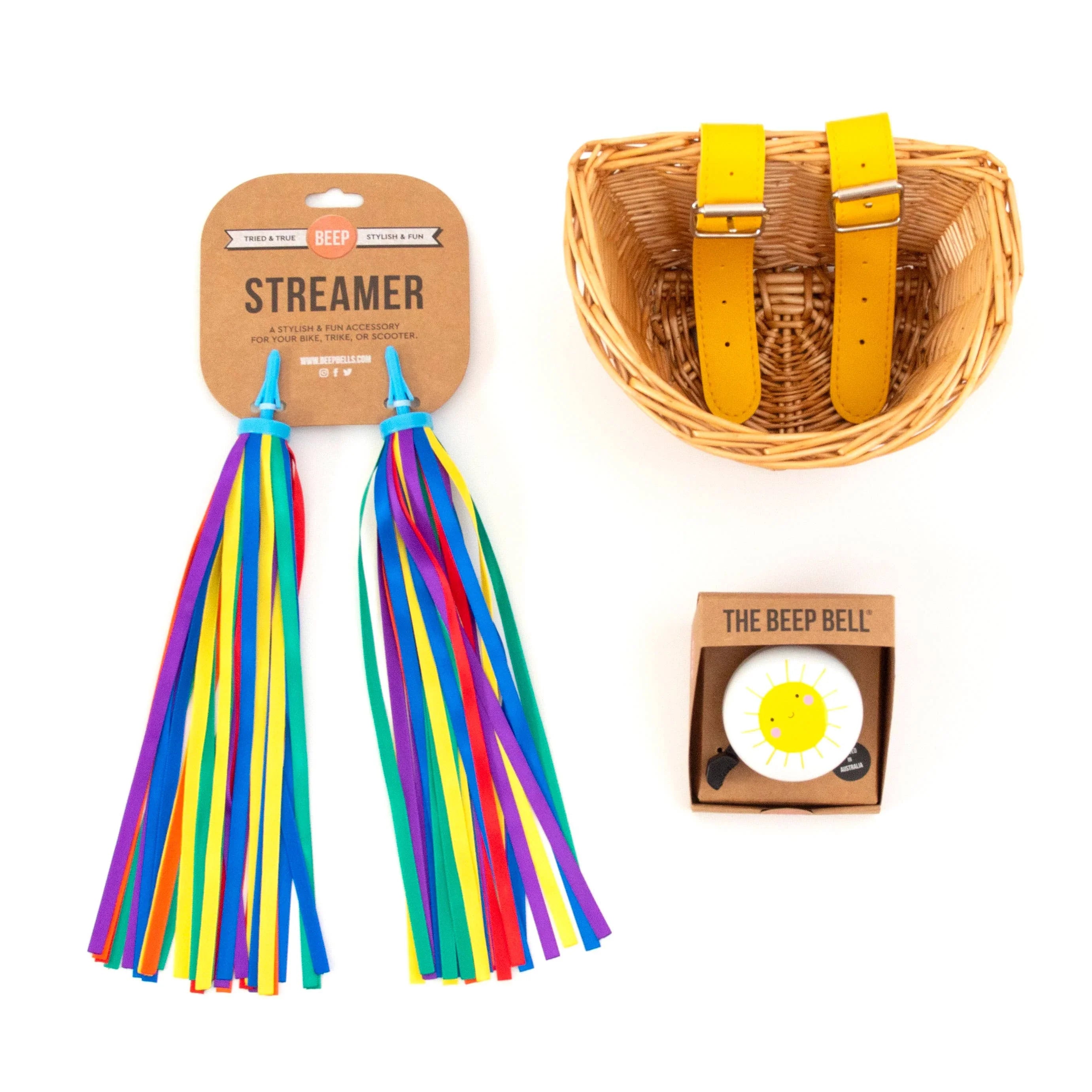 Rainbow bike streamers, wicker basket with yellow straps, and sun-themed bike bell for fun outdoor rides