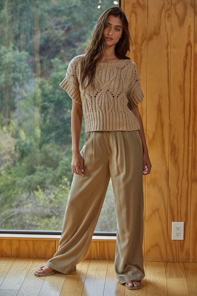 Woman in cozy knit top and wide-leg pants, coastal PNW style for beach days and trail adventures