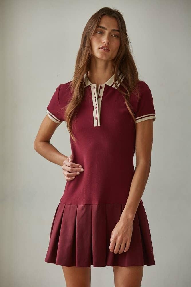 Burgundy polo dress with pleated skirt and cream trim, perfect for coastal weekends and outdoor adventures.