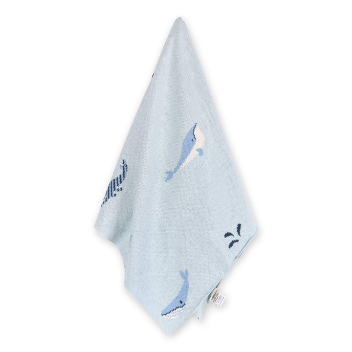 Light blue baby blanket with whale print, soft knitted fabric for nursery or travel