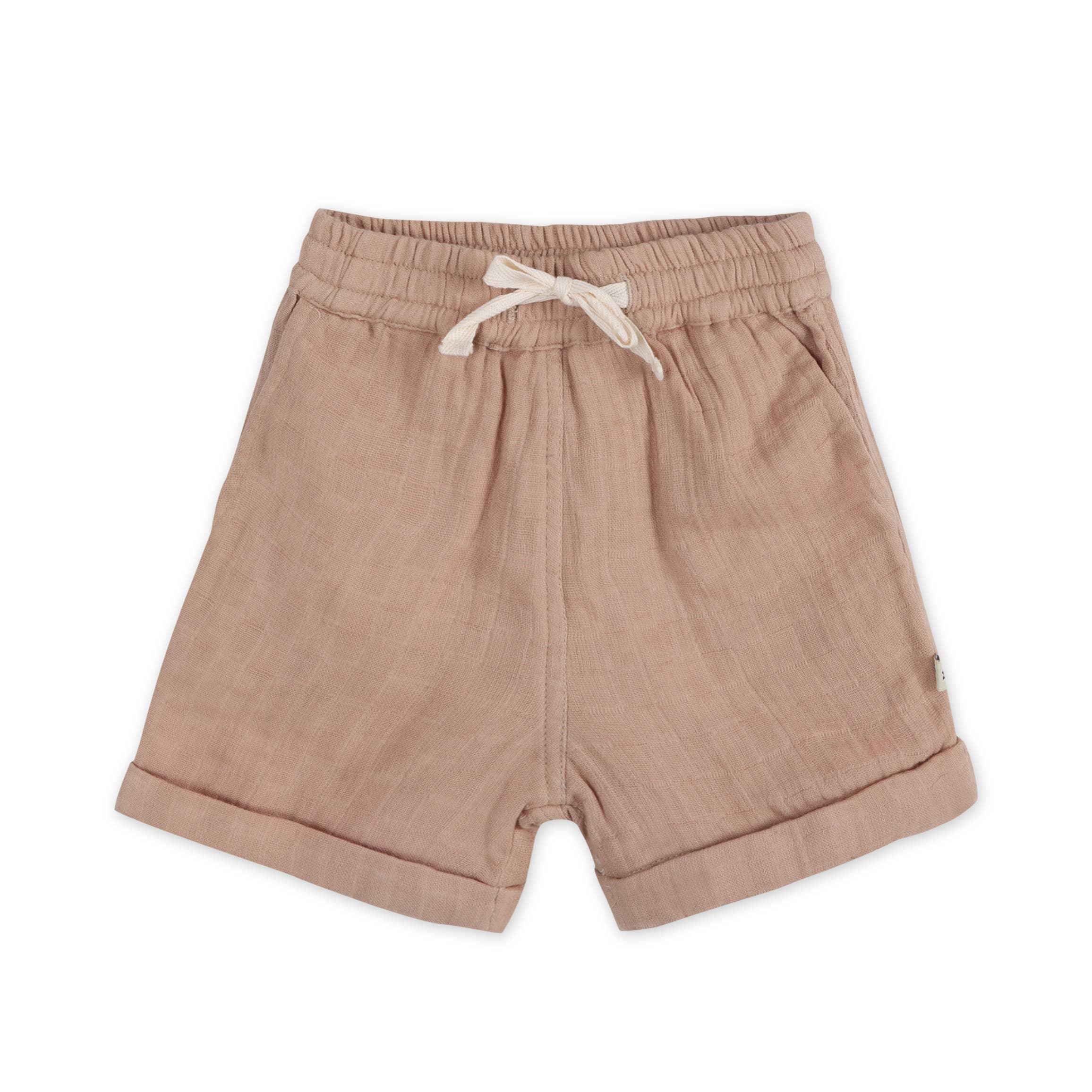 Soft beige toddler shorts with elastic waist and drawstring, ideal for casual comfort.