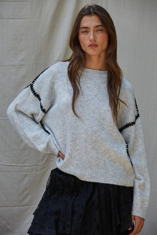 Cozy gray sweater with black trim, styled for PNW coastal adventures and everyday outdoor wear.