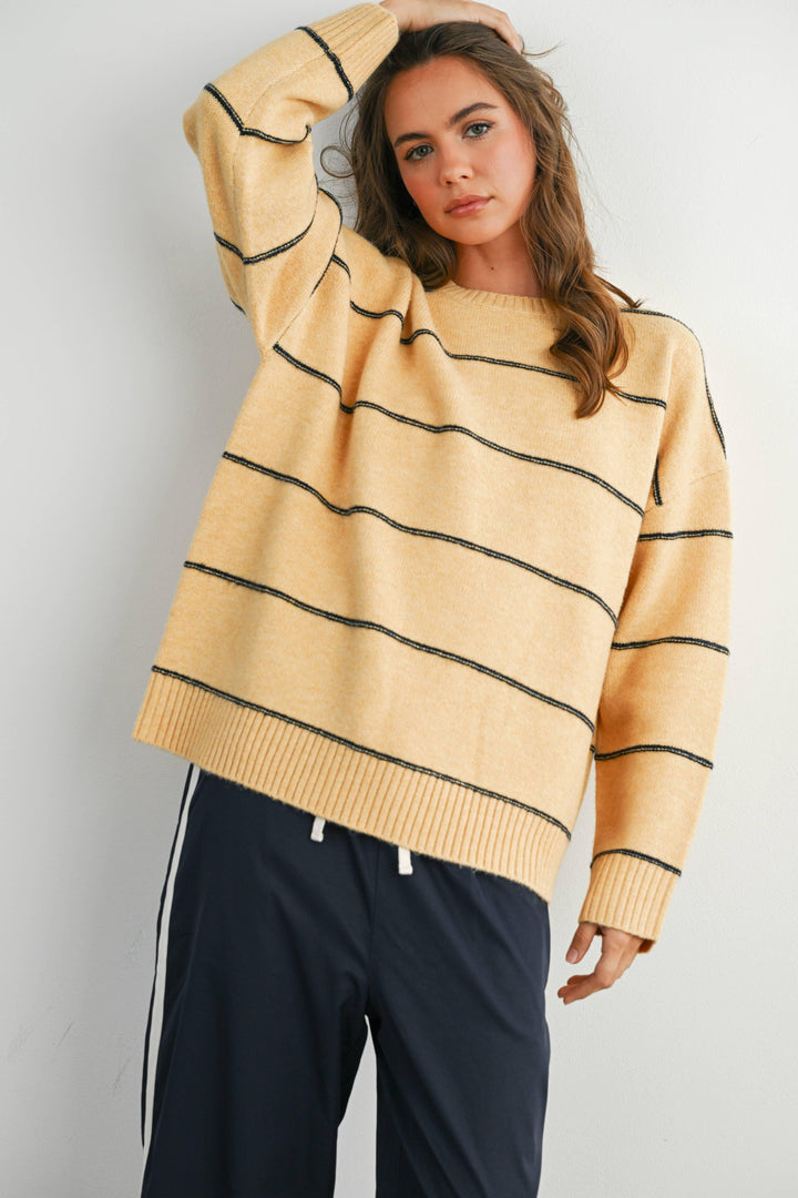Yellow wavy striped sweater with ribbed cuffs, cozy coastal style for PNW adventures
