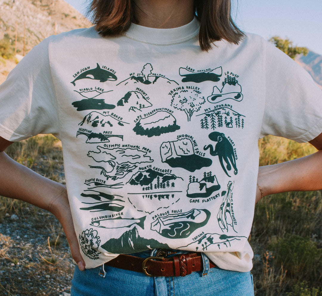 PNW adventure map t-shirt featuring iconic landmarks like Mt. Rainier, Olympic National Park, and Puget Sound for outdoor enthusiasts.