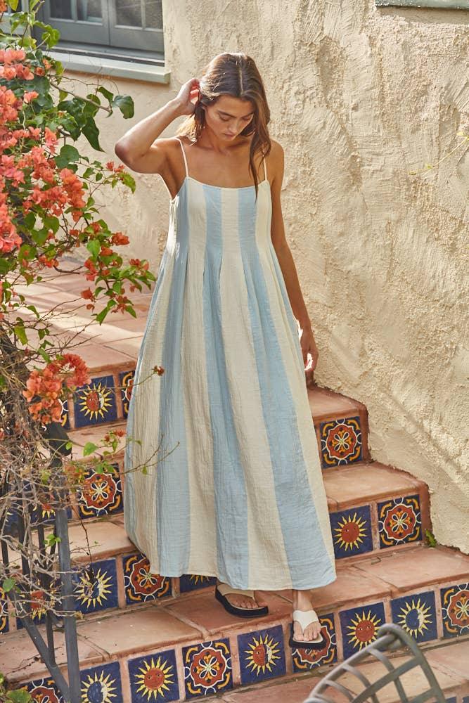Woman in blue and white striped sundress on tiled steps, coastal style outfit