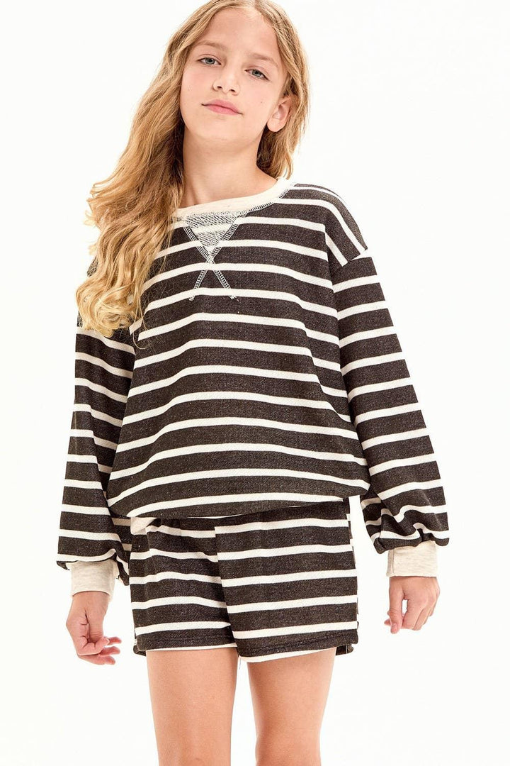 Girl in black and white striped long sleeve top and matching shorts, coastal style outfit