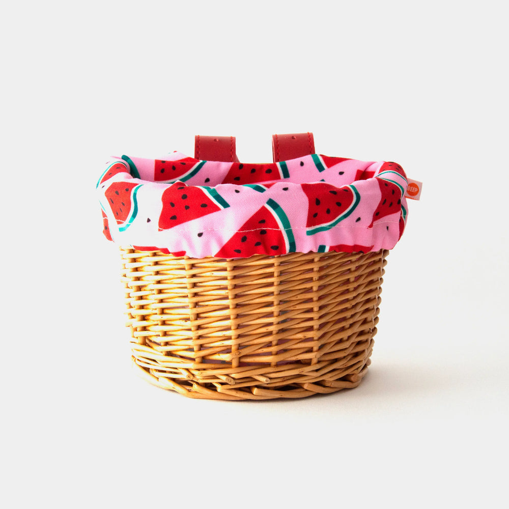 Woven bike basket with watermelon print liner for coastal adventures