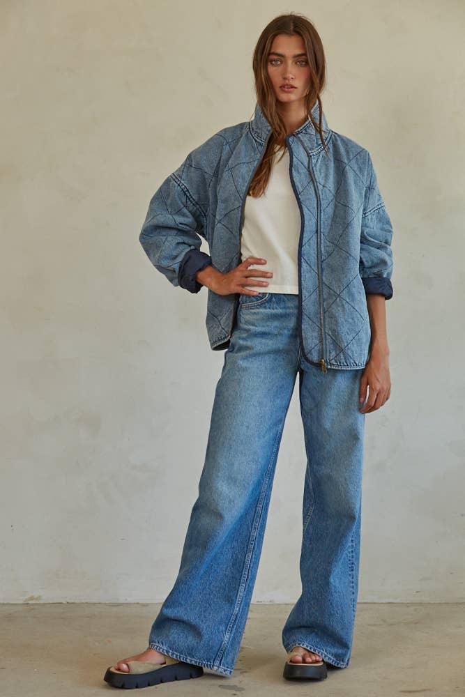 Woman in denim quilted jacket and wide-leg jeans, coastal outdoor style