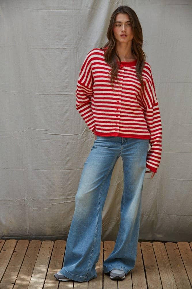 Woman in red and white striped cardigan with wide-leg jeans, coastal outdoor style