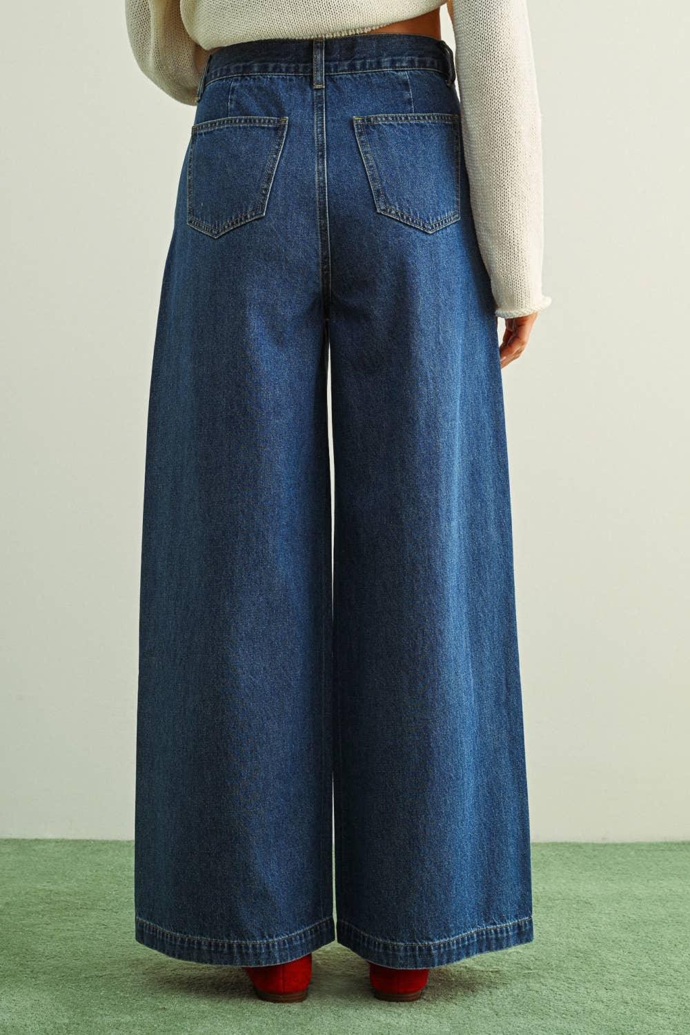 Wide leg denim jeans with back pockets, styled with cream sweater and red shoes