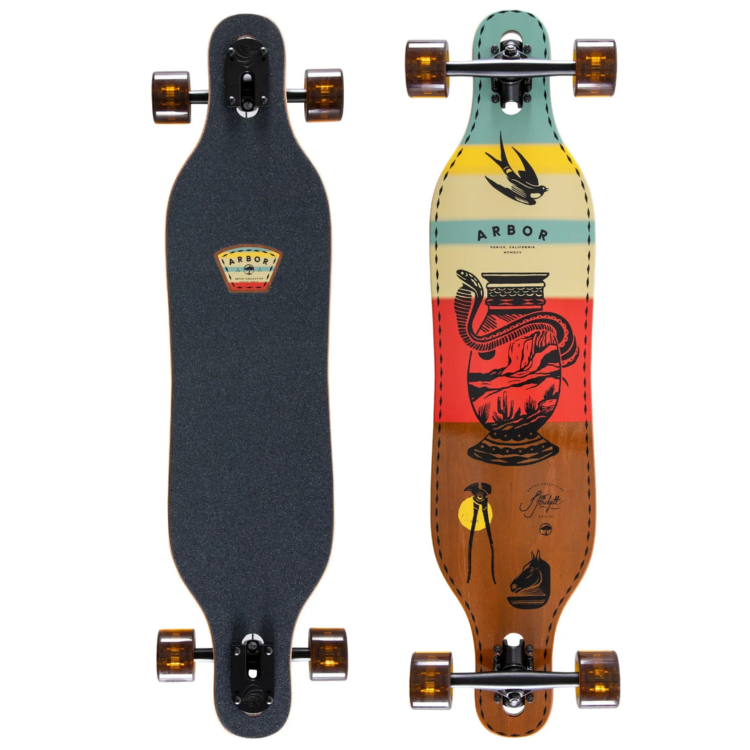 Arbor longboard with colorful desert art design and black grip tape, ideal for coastal cruising and PNW adventures.
