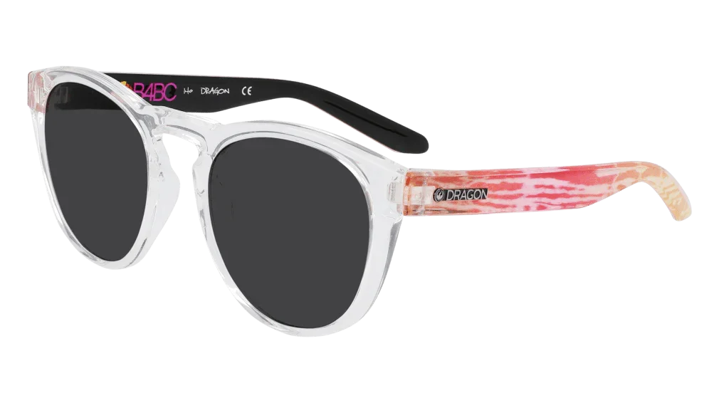 Clear frame sunglasses with pink tie-dye arms and black lenses, featuring Dragon branding