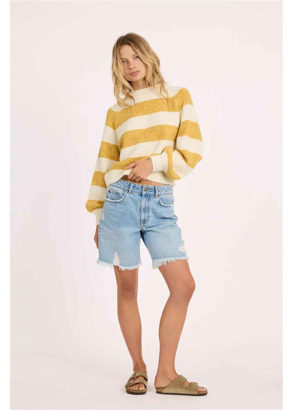 Yellow and white striped sweater with distressed denim shorts and sandals for coastal PNW style