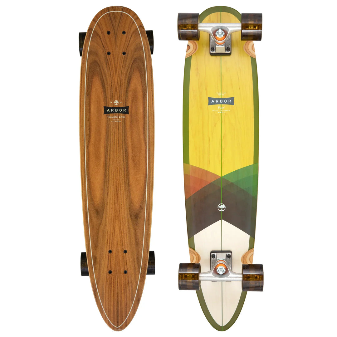 Top and bottom views of an Arbor Foundation Breach longboard with a wood grain finish.