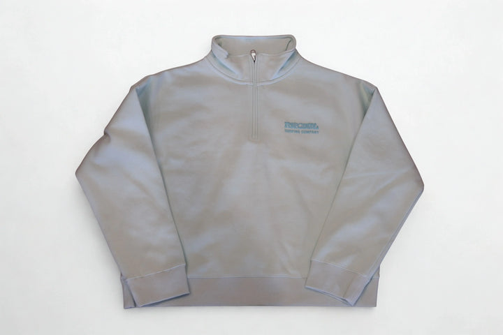 Light gray quarter-zip sweatshirt with subtle logo, ideal for casual or outdoor wear.