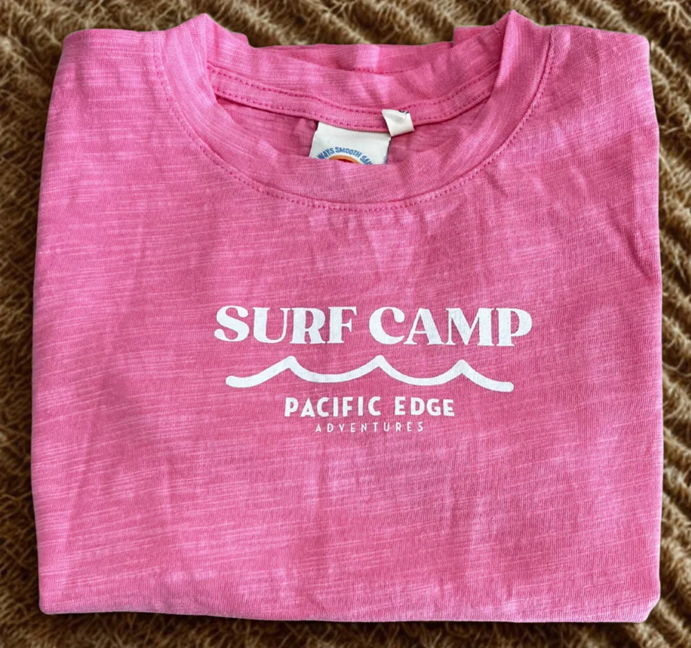 Pink Surf Camp t-shirt with Pacific Edge Adventures graphic, ideal for coastal adventures and beach days.
