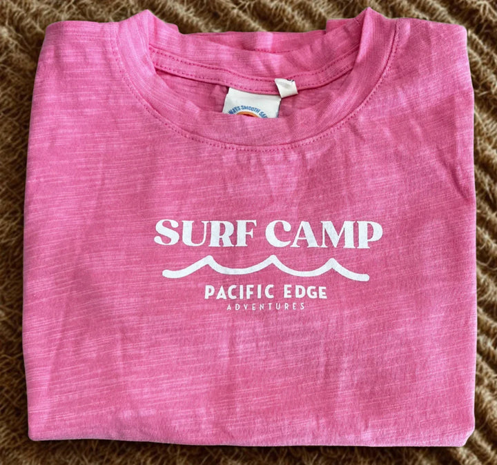 Pink Surf Camp t-shirt with Pacific Edge Adventures graphic, ideal for coastal adventures and beach days.