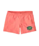 Coral swim trunks with green logo, perfect for beach days and coastal adventures in PNW style.
