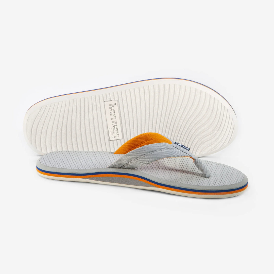 Gray and orange flip flops with textured sole, perfect for beach days and coastal adventures