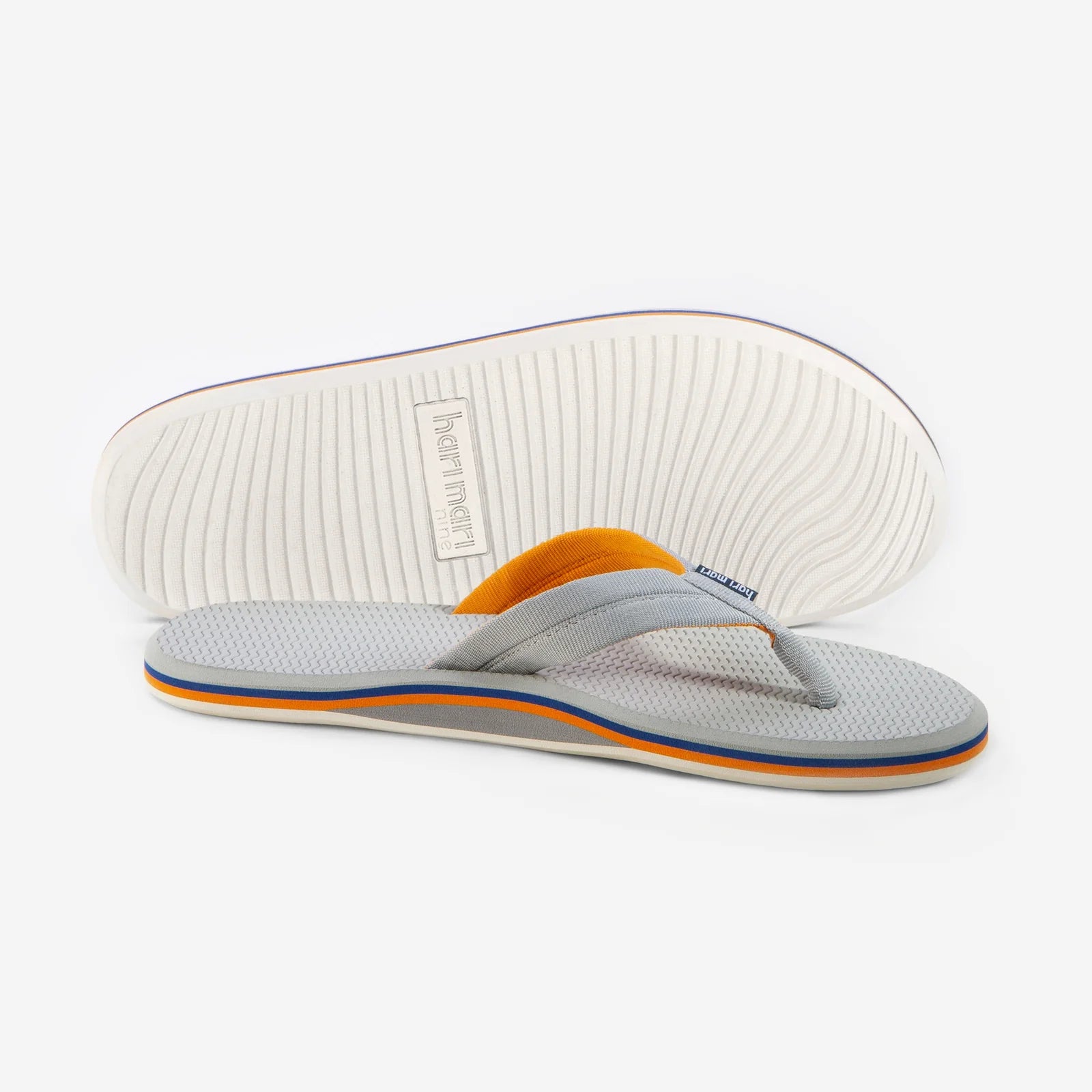 Gray and orange flip flops with textured sole, perfect for beach days and coastal adventures