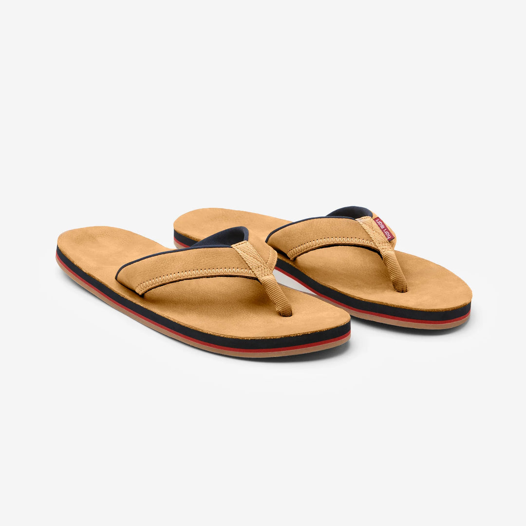 Tan flip flops with navy and red trim, perfect for beach days and coastal adventures