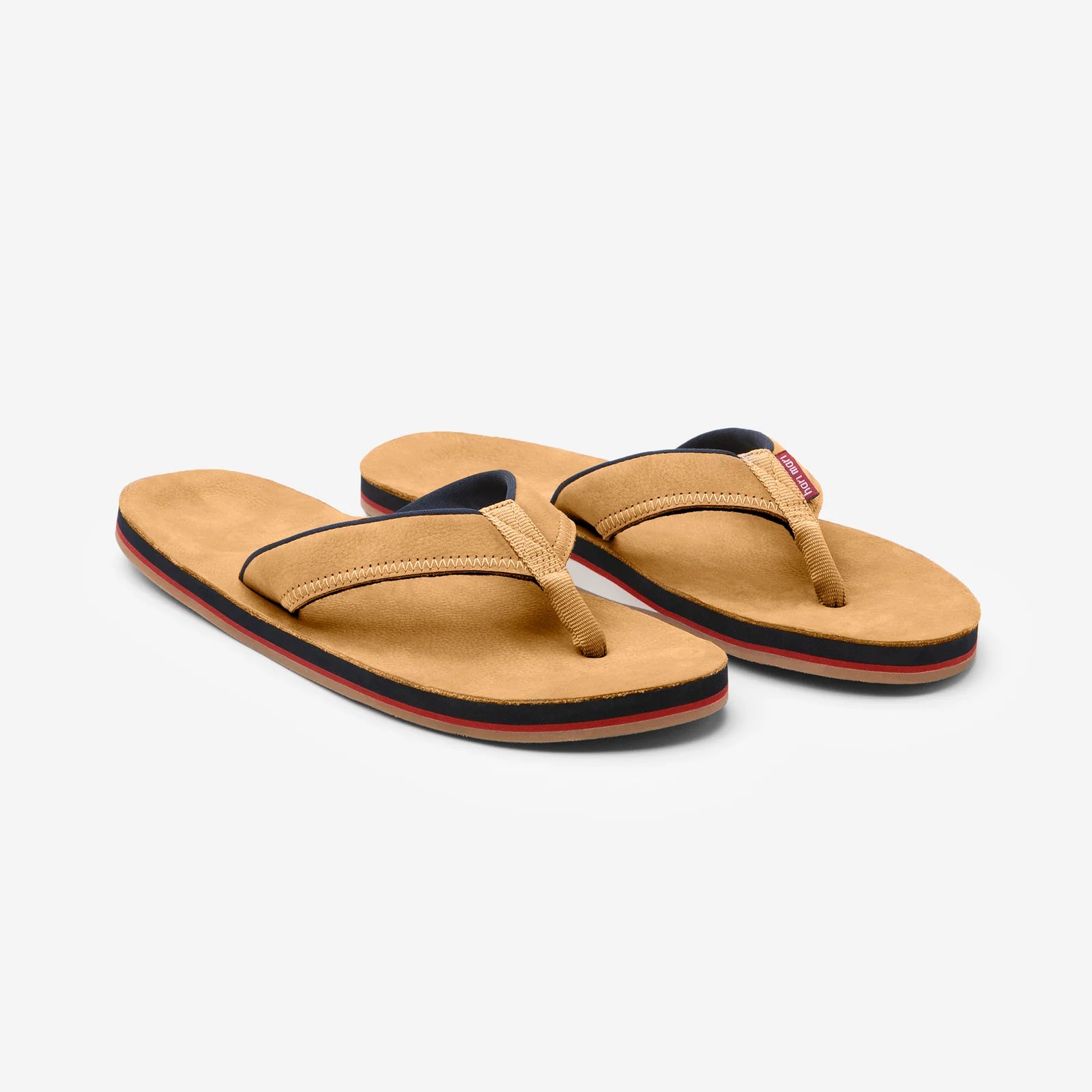 Tan flip flops with navy and red trim, perfect for beach days and coastal adventures