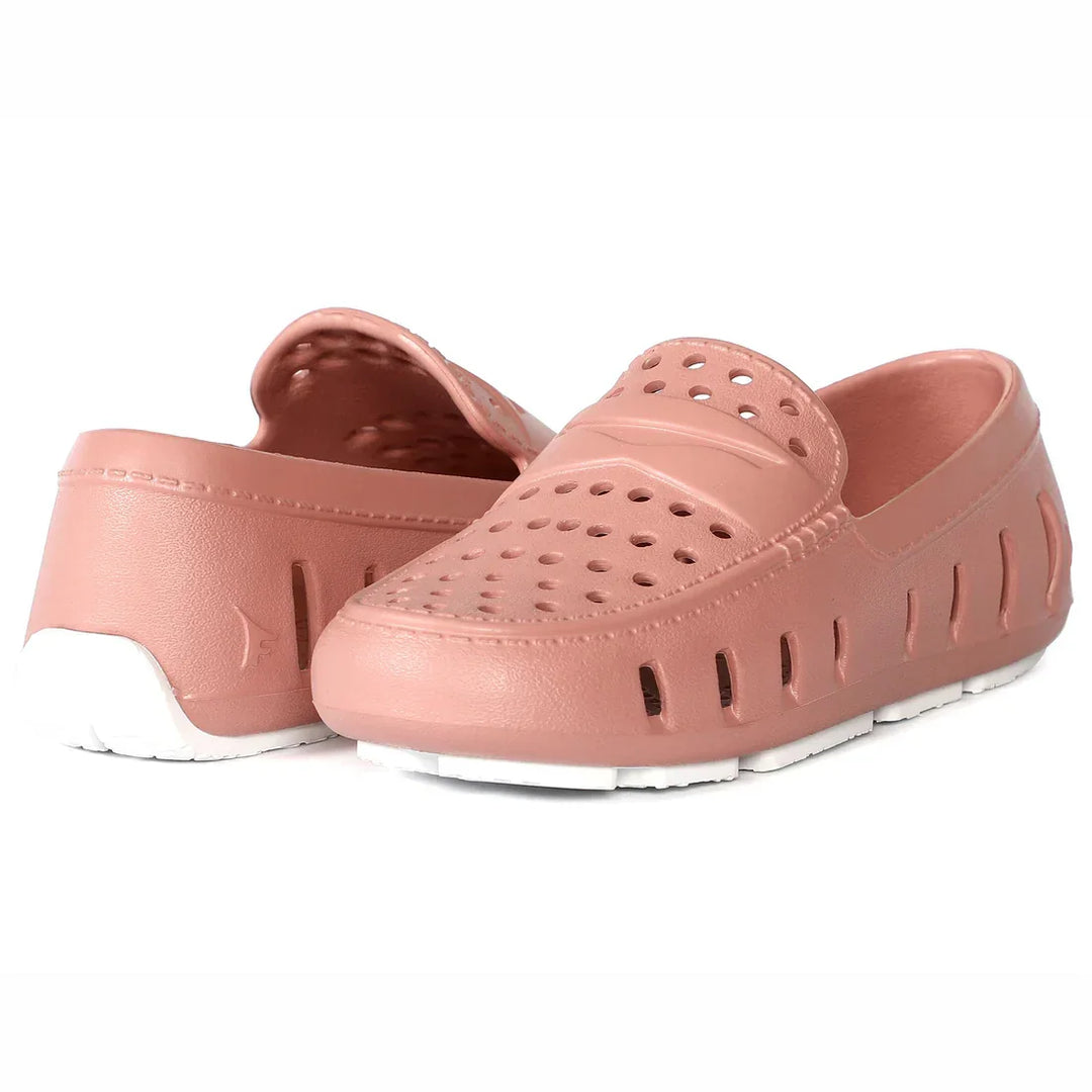 Pink perforated water shoes with white sole, ideal for beach or pool activities