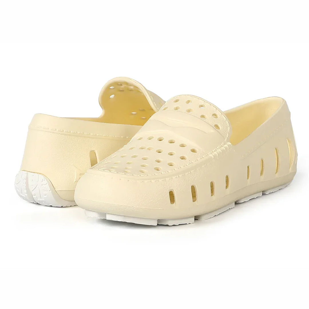 Cream perforated slip-on water shoes for beach or pool, lightweight and breathable design