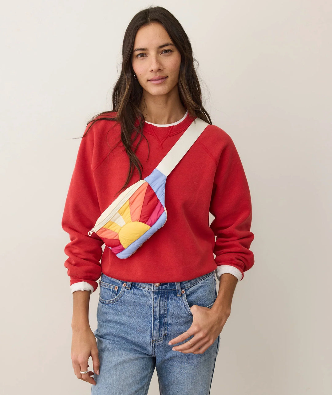 Woman in red sweatshirt wearing colorful quilted crossbody bag, perfect for coastal adventures and everyday PNW style.