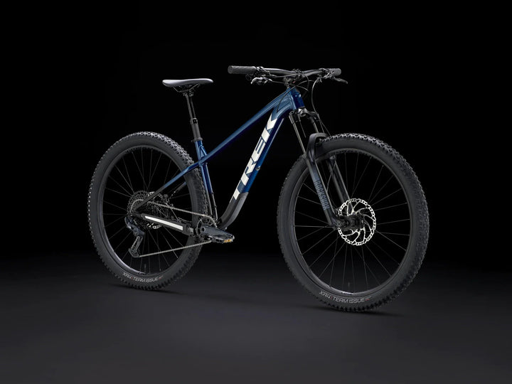 Blue Trek mountain bike with RockShox suspension and XR4 Team Issue tires on black background