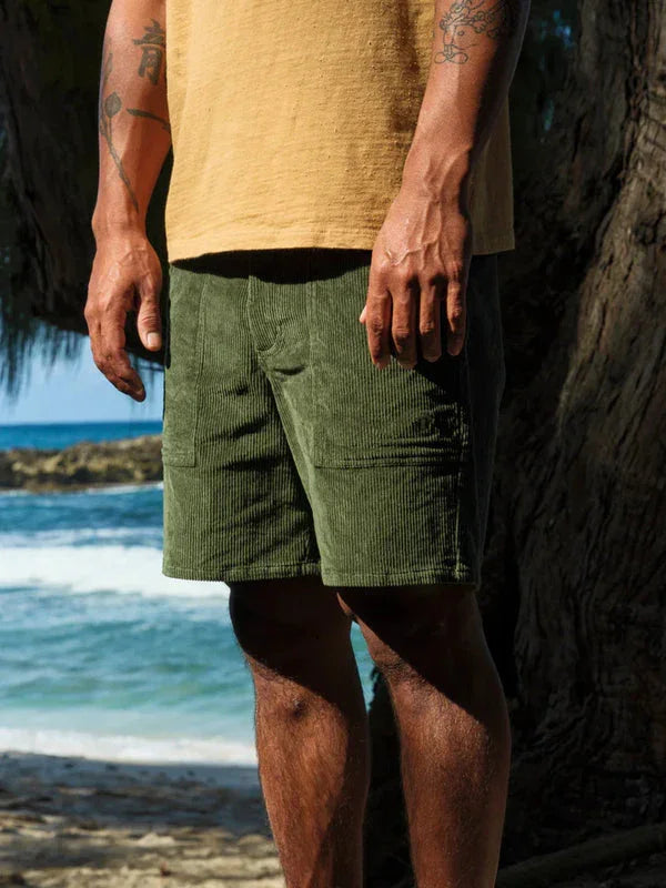 Olive corduroy shorts for beach days and coastal adventures near ocean waves
