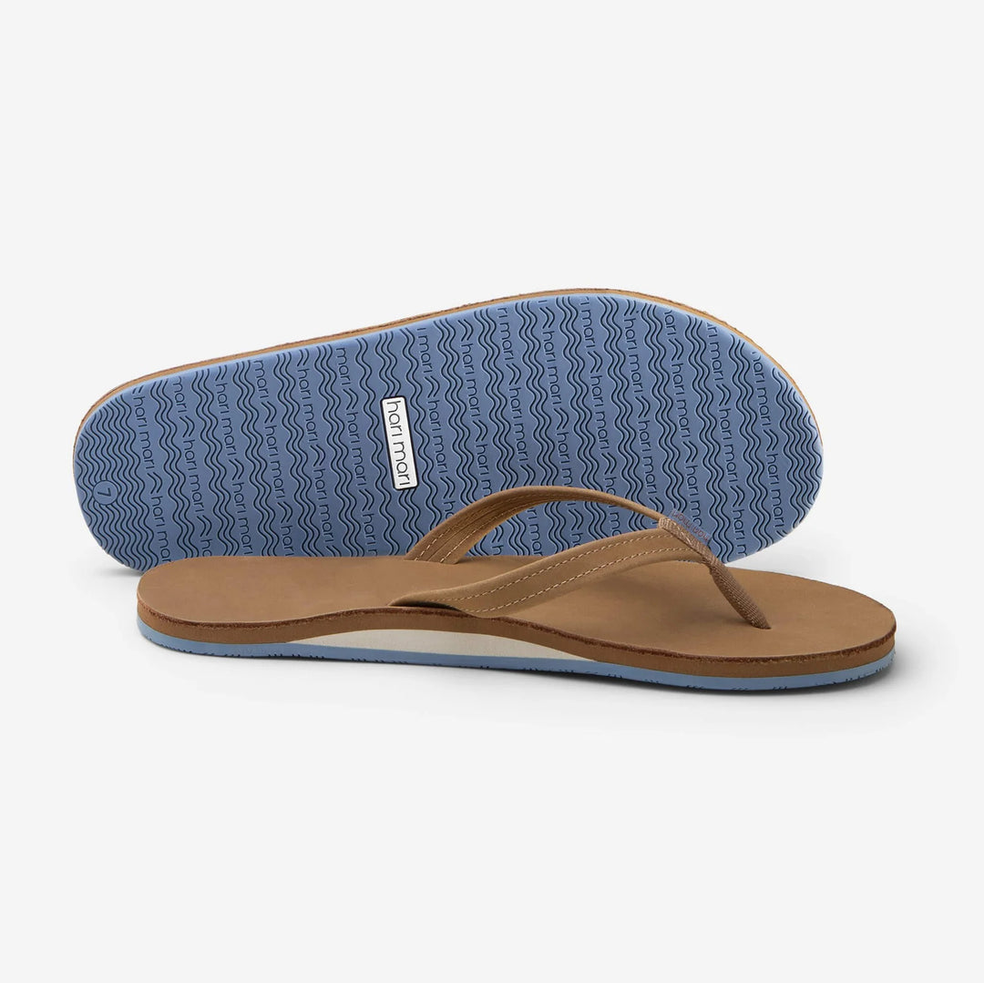 Tan flip flops with blue wavy sole, perfect for beach days and coastal adventures