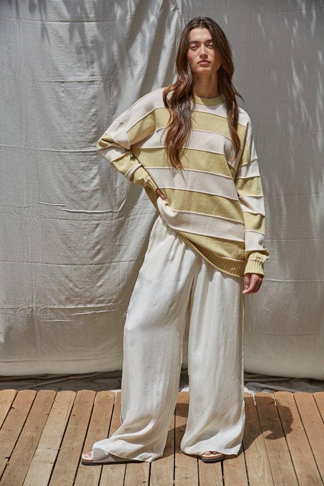 Woman in striped long-sleeve sweater and wide-leg pants, coastal outdoor style