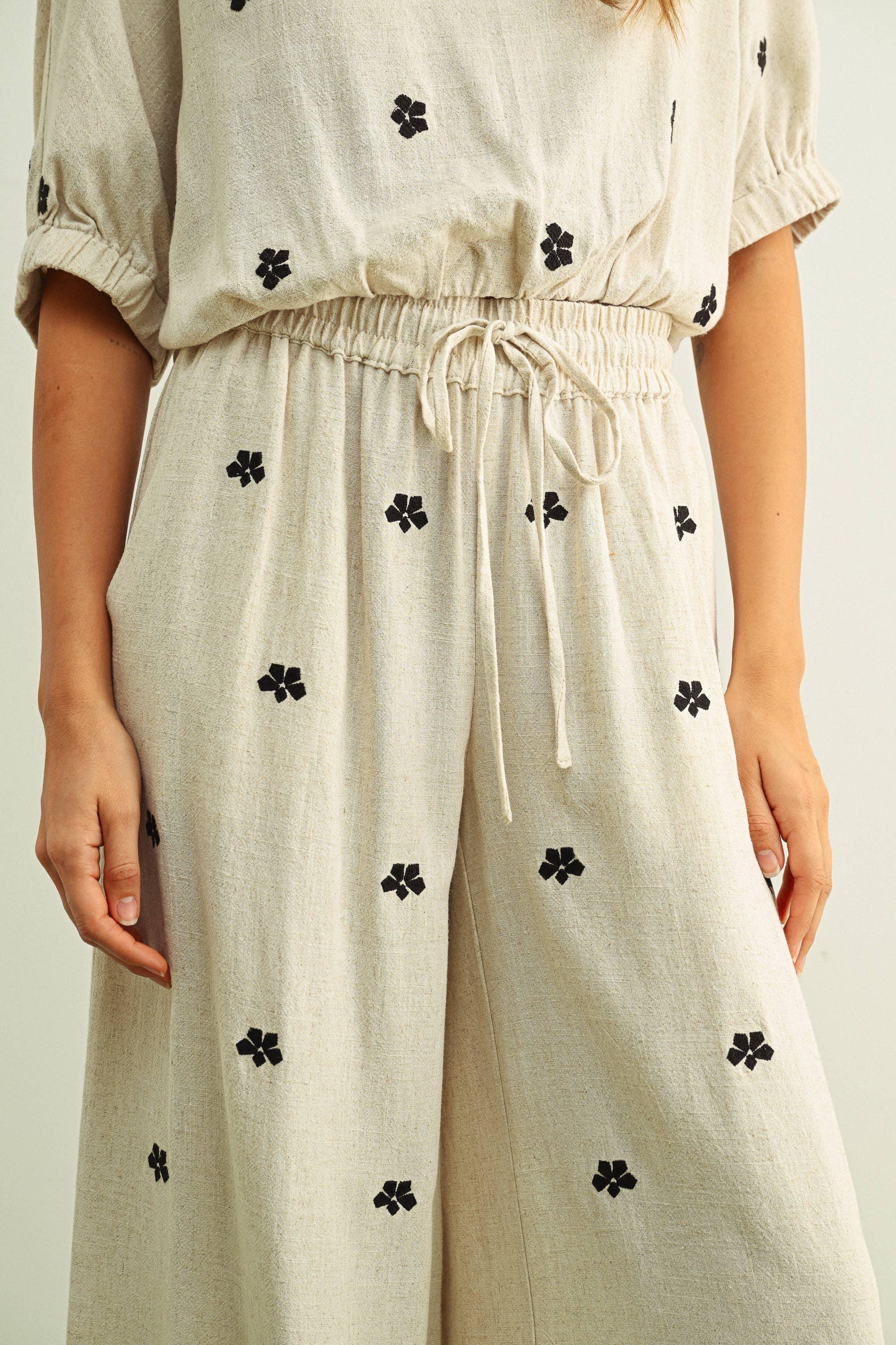 Beige floral print jumpsuit with drawstring waist and puff sleeves