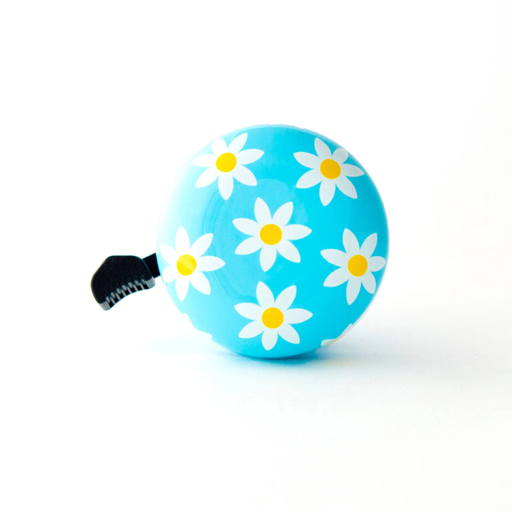 Blue bike bell with white daisy flowers, perfect for coastal rides and outdoor adventures