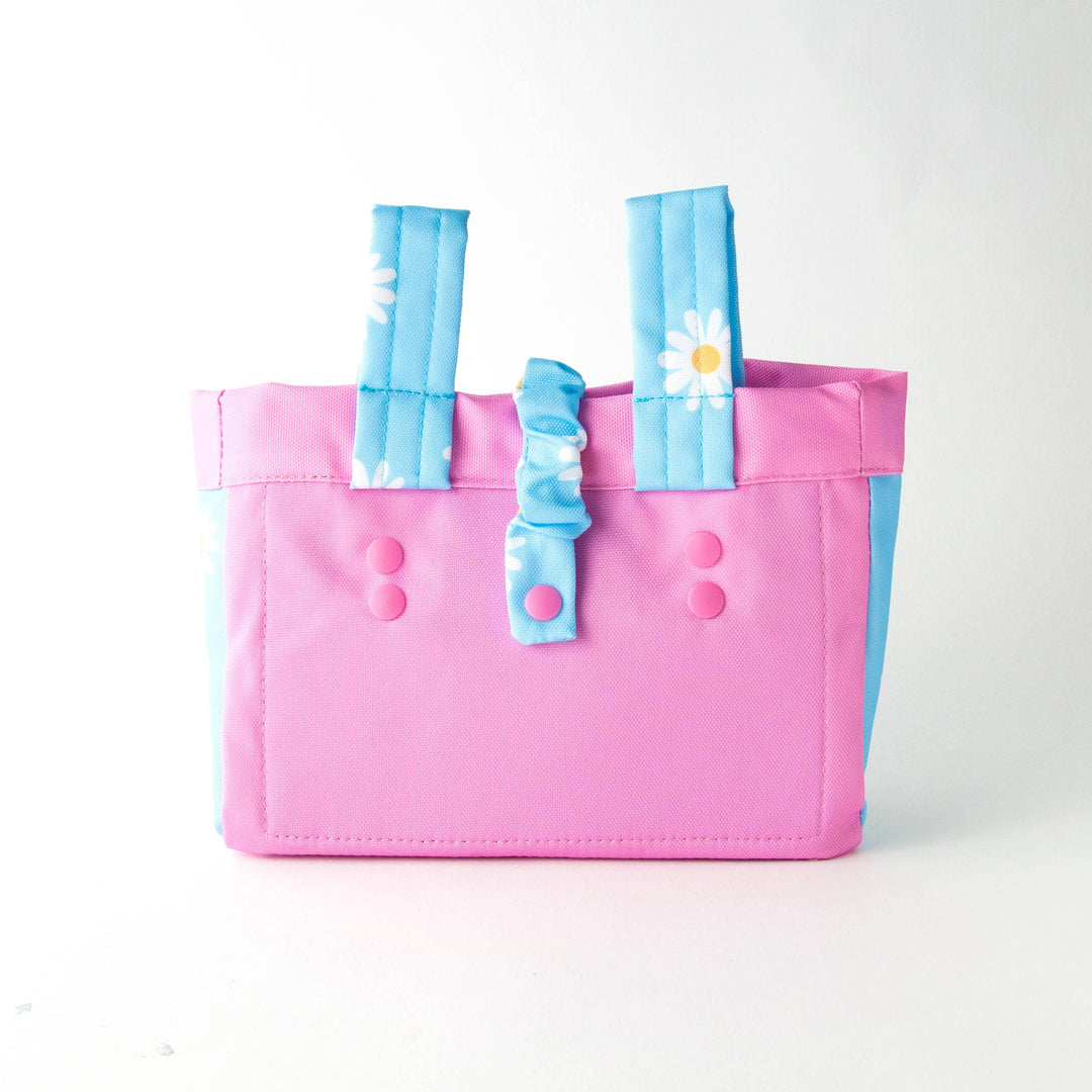 Pink and blue daisy-patterned tote bag with button details, perfect for beach days and outdoor adventures.