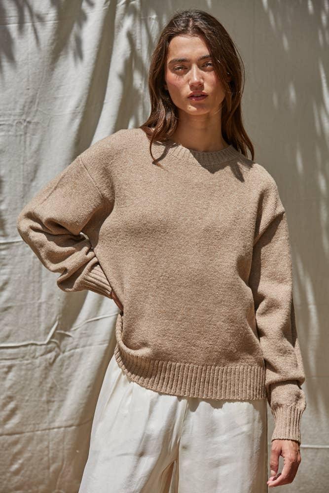 Cozy beige knit sweater with ribbed hem and cuffs, styled for coastal PNW outdoor lifestyle
