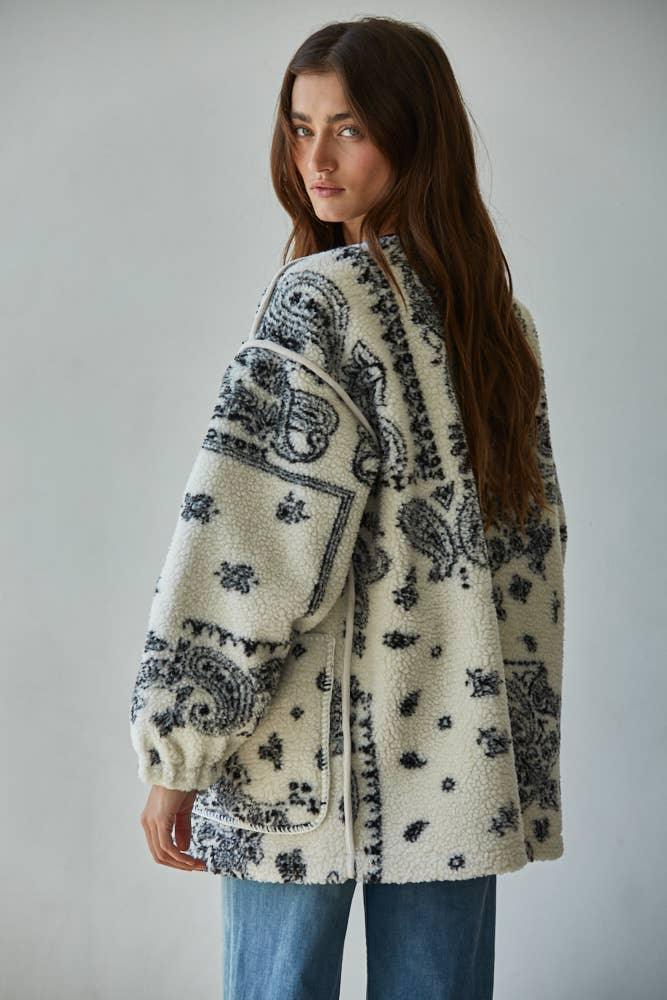 Cozy cream fleece jacket with black paisley print, perfect for PNW outdoor adventures and coastal style.